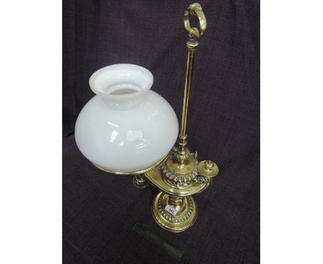 A 19th century brass student lamp of Aladin design, stamped Kosmos by Wild & Wessel with later shade.No apparent hole