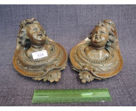 A pair of vintage treen Continental wall sconces modelled as cherubs head