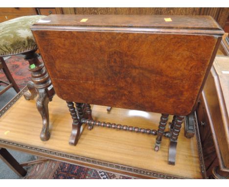 An Edwardian burr walnut Sutherland table having drop leaf top on bobbin gate leg frame