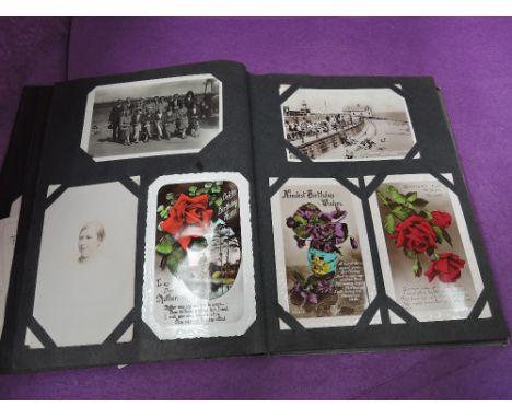 A collection of old postcards in a vintage album