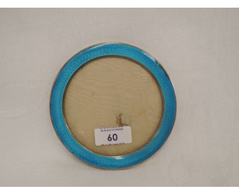 A silver photograph frame of circular form having blue guilloche enamel decoration, AF120mm diameter