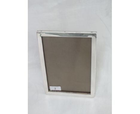 A silver rectangular photograph frame of plain form having wooden easel back, Birmingham 1922, Charles S Green & Co Ltd