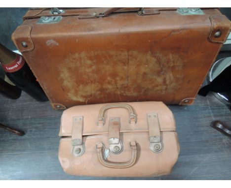 A vintage portmanteau and a vintage leather suitcase 