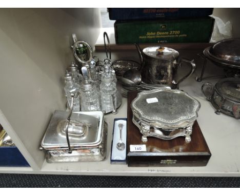 A selection of plated ware including 6 bottle condiment set, teapot, flatware etc