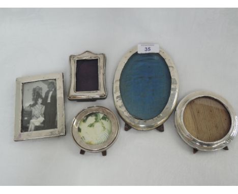 Five HM silver photograph frames of plain form having wooden and material easel backs