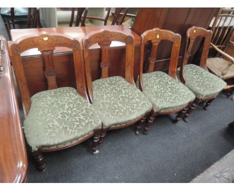 A set of four late Victorian mahogany salon/dining chairs having incised and sweep back with later 20th century green upholst