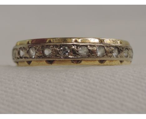 A lady's full eternity ring set with spinels on a yellow metal mount stamped 18ct, size O