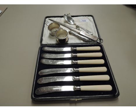 A cased set of butter knives having silver collars, Sheffield 1919, two HM silver napkin rings, HM silver handled pickle fork