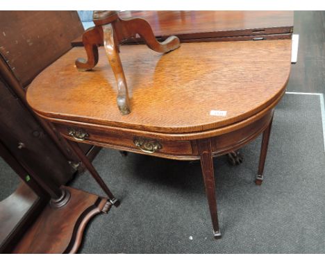 A 19th century golden oak card table having 'D' top with frieze drawer on tapered gate legs