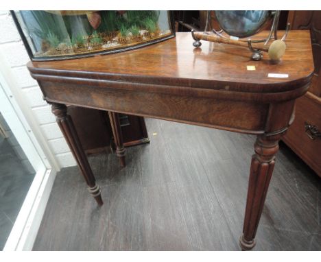 An early 19th century rosewood tea table having fold over top on reeded gate legs