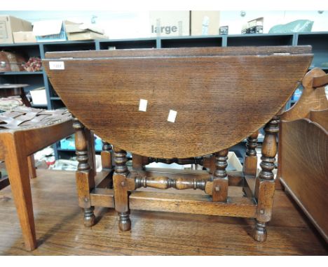 A late 20th century oak period style occasional table having drop leaf top, on turned gate legs 