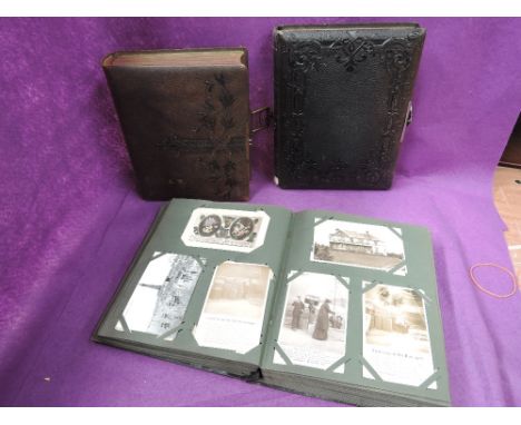 A vintage postcard album containing approximately 400, mixed subjects plus two empty Victorian photograph albums