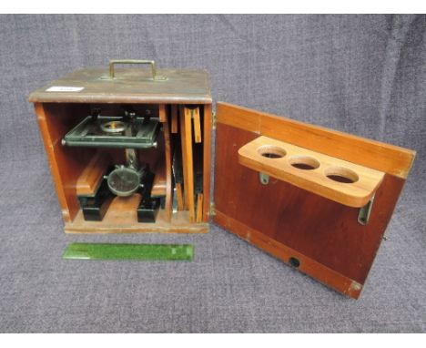 A vintage student microscope in fitted box with accessories 
