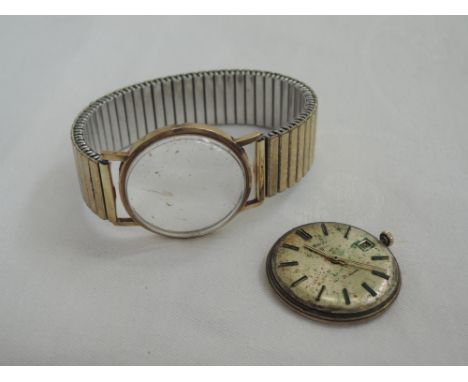 A gents 9ct gold wrist watch by Rotary having a baton numeral dial with date aperture on a plated stretch strap