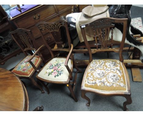 Four late Victorian/Edwardian mahogany salon chairs having vase and spindle backs with later tapestry seats on slender cabrio