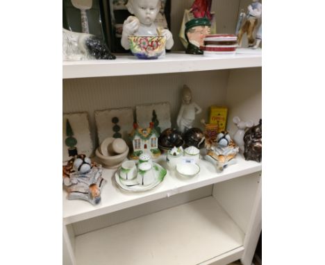 Shelf of collectables includes tiger plaques etc . 