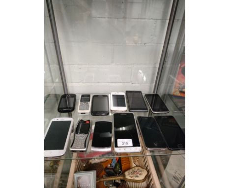 Shelf of mobiles includes ipod . 