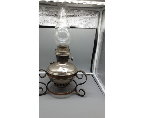 Early 1900s oil lamp on stand . 