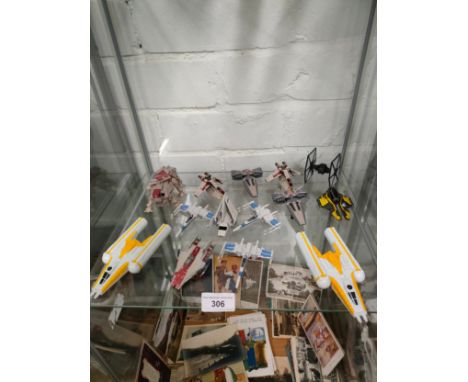 Shelf of star wars collectable vehicles . 