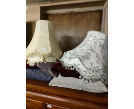 Selection of pillows and light shades . 