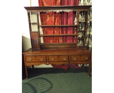 A 19th Century Oak Dresser with Two Drawers and Pot Shelf Under. Shaped Apron. Three Shelf Plate Rack Over. 145cm Wide. 