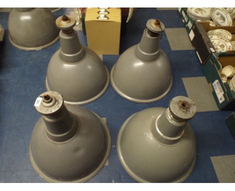 A Collection of Four Industrial Enamelled Lamp Shades 
