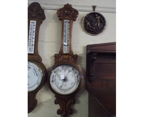 A Late Victorian Carved Oak Onion Top Wheel Barometer by Lennie and Thomson