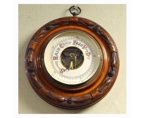 Early 20th Century carved beech framed circular aneroid barometer, the dial with visible mechanism   Condition: 