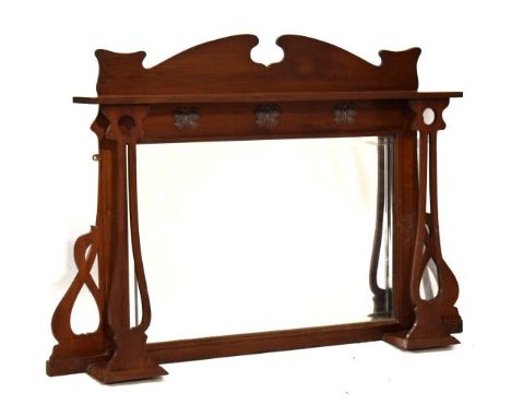 Edwardian walnut overmantel having a shaped pediment, open shelf supported by Art Nouveau design pierced columns, the mirrore