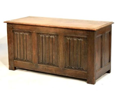 Early 20th Century oak three-panel coffer in the 16th Century taste, with planked moulded top over three 'linen fold' panels 