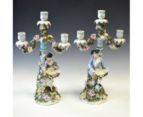 Pair of 19th Century Plaue-on-Havel figural three branch candelabra, each having allover floral encrusted decoration and with