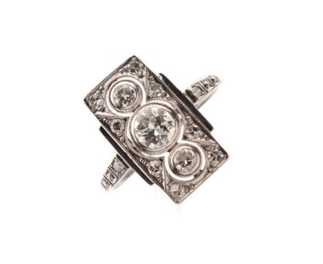 Unmarked white metal and eleven diamond panel ring set large central stone between two smaller within a border of small stone