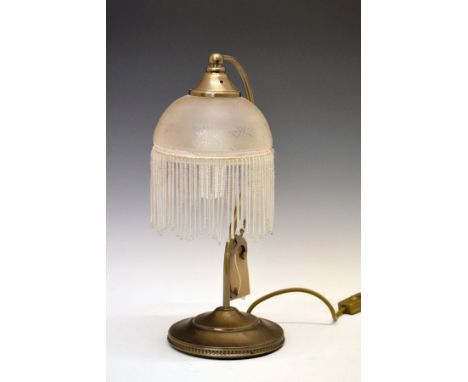 1920's-style table lamp having a tasselled shade on scroll stem and stepped circular base   Condition: 