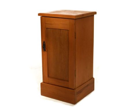 Early 20th Century pine bedside cabinet with panelled door enclosing shelf   Condition: 