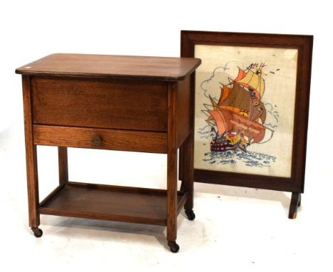 1930's oak sewing/work box with hinged cover over single drawer on trolley base with undershelf, together with a tapestry fir