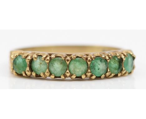 A 9ct gold and emerald half eternity ring, R, 2.1gm