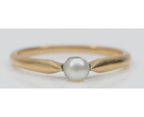 An early 20th century unmarked gold and 4mm pearl ring, tests 15ct, possible natural pearl, K 1/2, 1.4gm