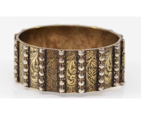 A heavy unmarked silver gilt hinged bangle, with slide clasp, 58 x 53mm, 90gm