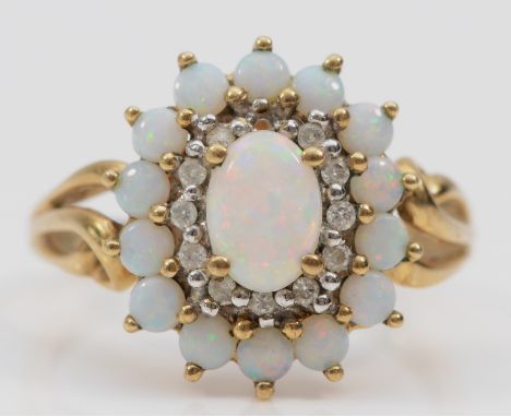 A 9ct gold opal and brilliant cut diamond cluster ring, one diamond vacant, 15 x 13mm, O, 3gm