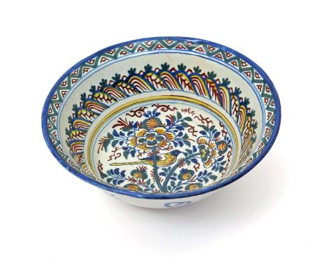 A London delftware bowl  c.1705, brightly enamelled to the interior in shades of blue, green, yellow and red, with a bird per