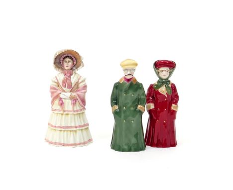 A pair of Royal Worcester candle snuffers  20th century, of The Motorists, the couple wearing motoring goggles and long overc