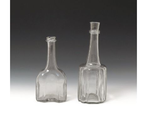 Two glass serving bottles or decanters  c.1740, one of octagonal moulded form, the other cruciform, both with long tapering n