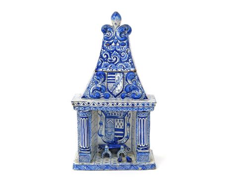 A Delft model of a fireplace  19th century, forming a storage jar and cover, modelled as a recessed hearth enclosing logs on 