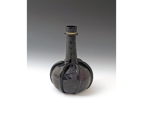An amethyst glass decanter  18th century, of bottle form with a long tapering neck issuing from a squat globular body, applie