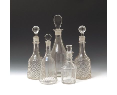 Five decanters and stoppers  19th century and later, a pair possibly Irish and moulded with a large honeycomb design to the m