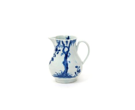 A rare Worcester blue and white milk jug  c.1754-56, painted with the Weeping Willow pattern, a flowering creeper entwined ar