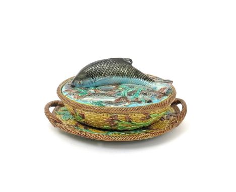 A George Jones Majolica sardine dish with cover and stand  c.1876, the oval form applied with seaweed fronds over basket moul