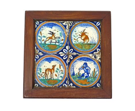 A Delft four tile panel  early 17th century, possibly English, each tile painted in polychrome enamels with a single animal i