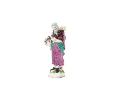 A miniature Chelsea figure of a mother and child  c.1753-55, the rustic lady wearing a green headscarf and burgundy cloak whi