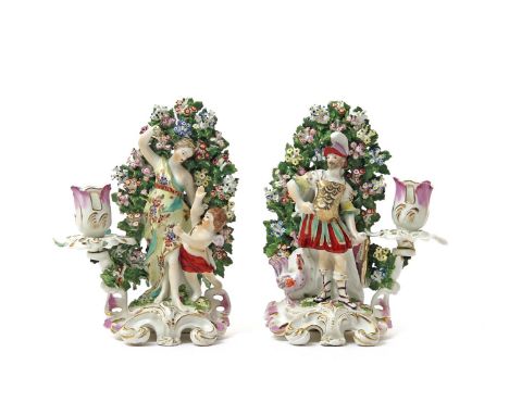 A pair of Derby candlestick figures of Mars and Venus  c.1765-70, Mars with a cockerel by his side, Venus chastising a putto,